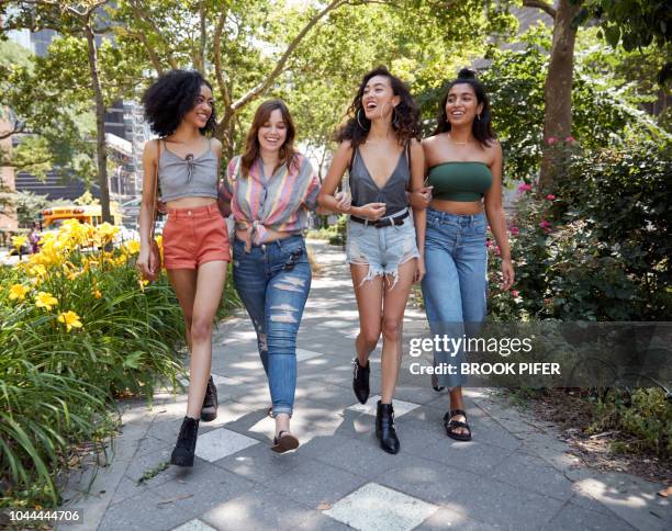 young females hanging out in city - black shorts stockfoto's en -beelden