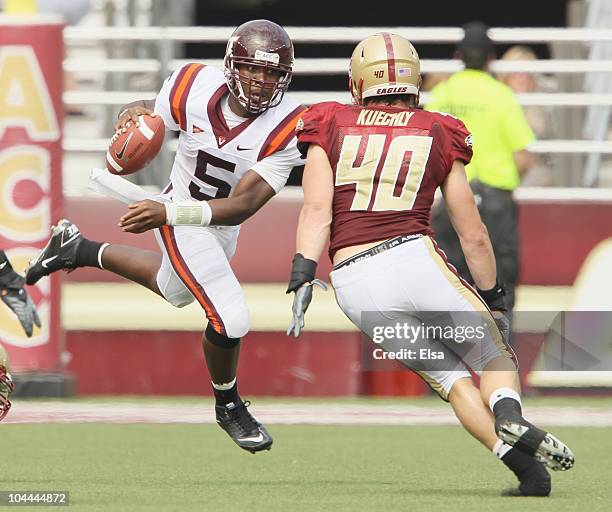 Tyrod Taylor of the Virginia Tech Hokies scrambles with the ball as Luke Kuechly of the Boston College Eagles defends on September 25, 2010 at Alumni...