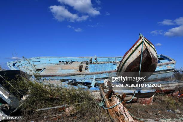 The so-called boat cemetery, where skiffs are dumped after the migrants and refugees' crossing from North Africa, is pictured in Lampedusa on...