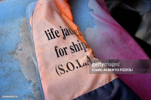 Life jacket marked with an inscription of the International Convention for the Safety of Life at Sea is pictured in the so-called boat cemetery,...
