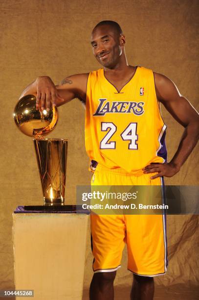 Kobe Bryant of the Los Angeles Lakers poses with the Larry O'Brien trophy at Media Day at Toyota Sports Center on September 25, 2010 in El Segundo,...