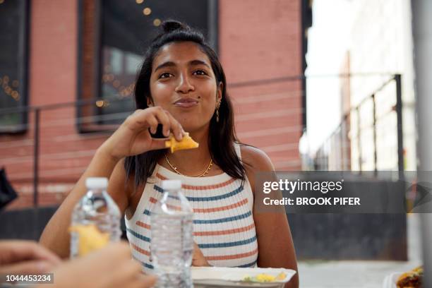 portrait of young woman eating - generation z food stock pictures, royalty-free photos & images