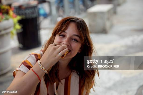 portrait of young woman eating - portrait woman food stock pictures, royalty-free photos & images