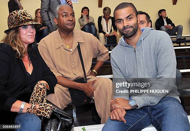 French Basket-ball player Tony Parker poses with his parents before the basket-ball match BC Orchies versus GET Vosges in which his brother Terence...