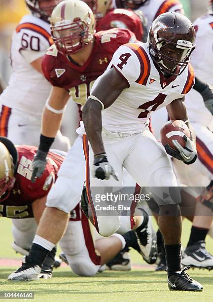 David Wilson of the Virginia Tech Hokies breaks free and carries the ball as Brad Newman of the Boston College Eagles defends on September 25, 2010...