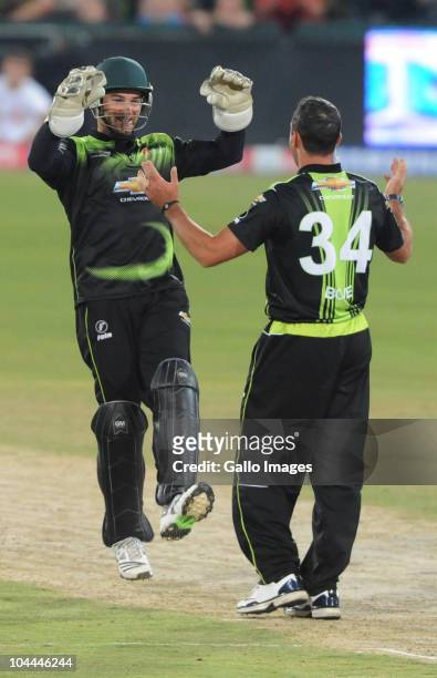 Nicky Boje celebrates the wicket of Graham Manou with team-mate Mark Boucher during the Airtel Champions League Twenty20 semi final match between...