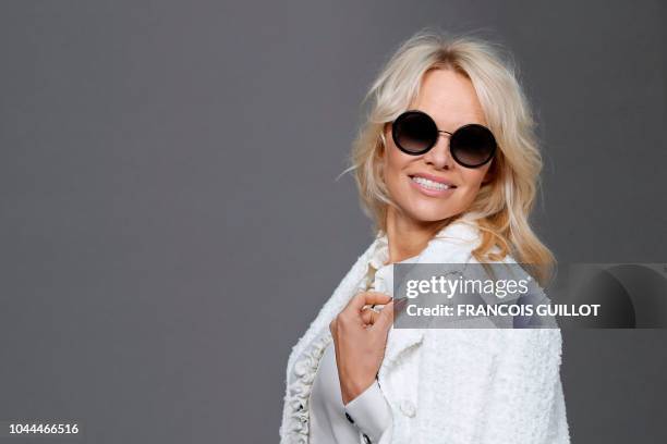 Canadian actress Pamela Anderson poses during a photocall prior to the Chanel Spring-Summer 2019 Ready-to-Wear collection fashion show at the Grand...