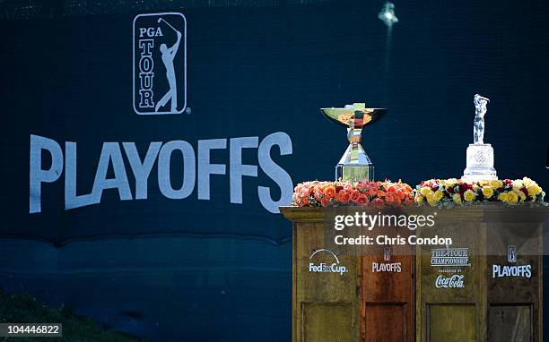 The tournament trophy and FedEx Cup are displayed on the first tee during the third round of THE TOUR Championship presented by Coca-Cola, the final...