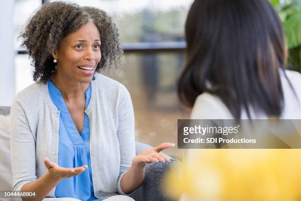 distraught mom talks with daughter - overworked teacher stock pictures, royalty-free photos & images