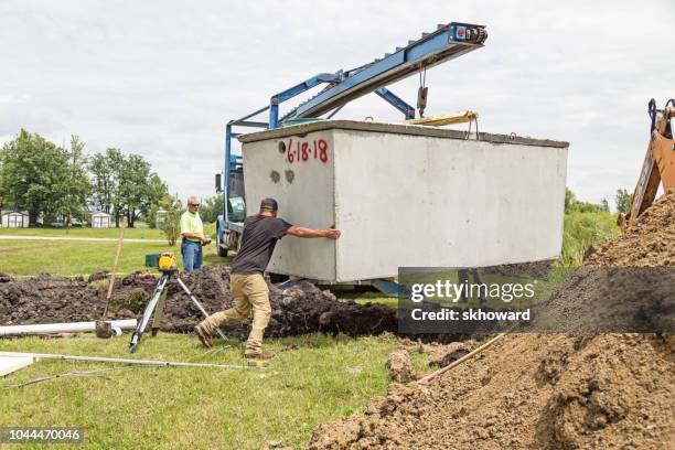 mound septic system installation - septic tank stock pictures, royalty-free photos & images