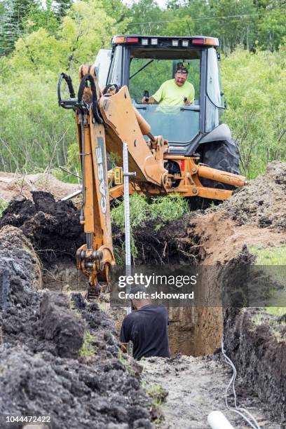 mound septic system installation - digging trench stock pictures, royalty-free photos & images