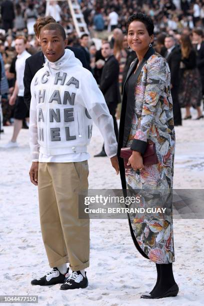 Rapper, artist and fashion designer Pharrell Williams and US model Helen Lasichanh arrive for the Chanel Spring-Summer 2019 Ready-to-Wear collection...