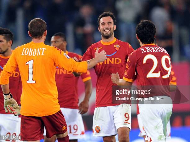 Goalscorer Mirko Vucinic of Roma celebrates his team's 1-0 victory with team-mates Bogdan Lobont and Nicolas Burdisso after the Serie A match between...