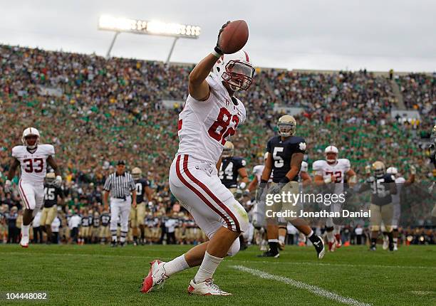 Coby Fleener of the Stanford Cardinal celebrates a touchdown catch against the Notre Dame Fighting Irish tries to defend at Notre Dame Stadium on...