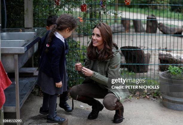 Britain's Catherine, Duchess of Cambridge, talks with school children during her visit to Sayers Croft Forest School and Wildlife Garden in London on...
