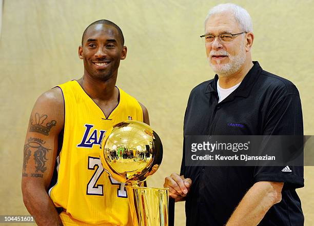 Kobe Bryant and head coach Phil Jackson of the Los Angeles Lakers pose with NBA Finals Larry O'Brien Championship Trophy during Media Day at the...