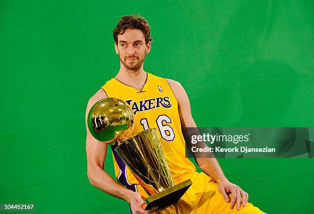 Pau Gasol of the Los Angeles Lakers poses for a photograph with the NBA Finals Larry O'Brien Championship Trophy during Media Day at the Toyota...