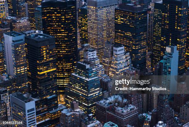 high angle shot of large group of skyscrapers in manhattan, new york city - new york city aerial stock pictures, royalty-free photos & images