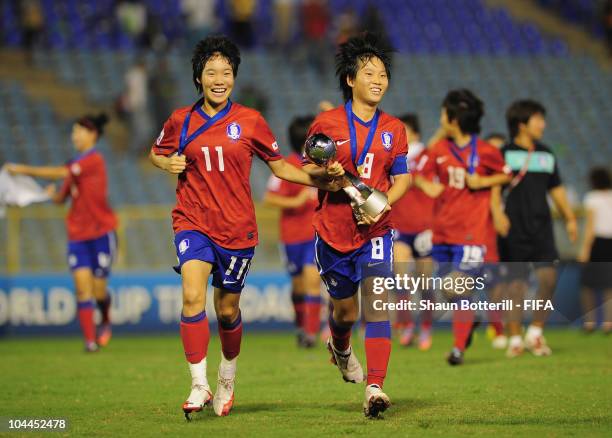 Kim Areum captain of South Korea and team-mate Lee Guem Min celebrate with the trophy at the end of of the FIFA U17 Women's World Cup Final match...