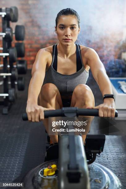 it's a commitment she makes everyday - rowing machine stock pictures, royalty-free photos & images