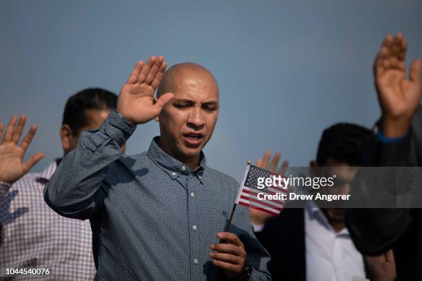New American citizens take the Oath of Citizenship during a naturalization ceremony at Liberty State Park, October 2, 2018 in Jersey City, New...