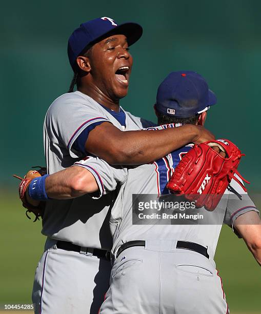 Neftali Feliz and Michael Young of the Texas Rangers celebrate winning the American League Western Division title after the game between the Texas...
