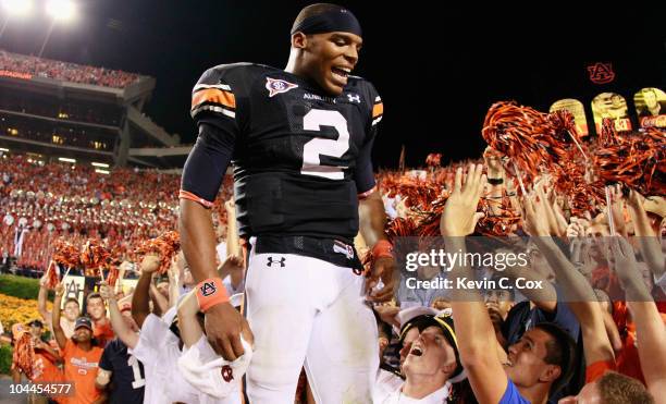 Quarterback Cameron Newton of the Auburn Tigers celebrates in the stands after their 35-27 win over the South Carolina Gamecocks at Jordan-Hare...