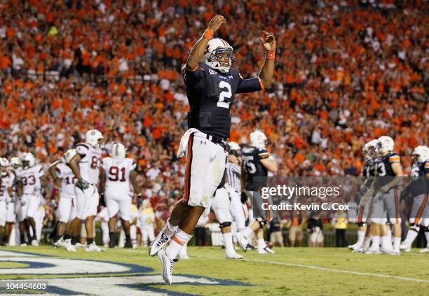 Quarterback Cameron Newton of the Auburn Tigers reacts after rushing in a touchdown against the South Carolina Gamecocks at Jordan-Hare Stadium on...