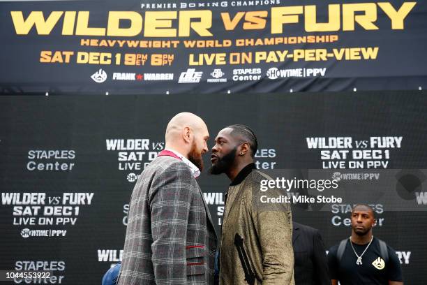 Heavyweight champion Deontay Wilder and Lineal Heavyweight champion Tyson Fury face-off during the New York Press Conference at Intrepid...