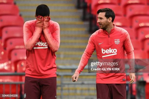 Barcelona's Uruguayan forward Luis Suarez and Barcelona's Argentine forward Lionel Messi attend a team training session at Wembley Stadium in north...