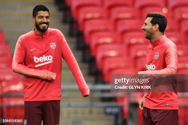 Barcelona's Uruguayan forward Luis Suarez and Barcelona's Argentine forward Lionel Messi attend a team training session at Wembley Stadium in north...