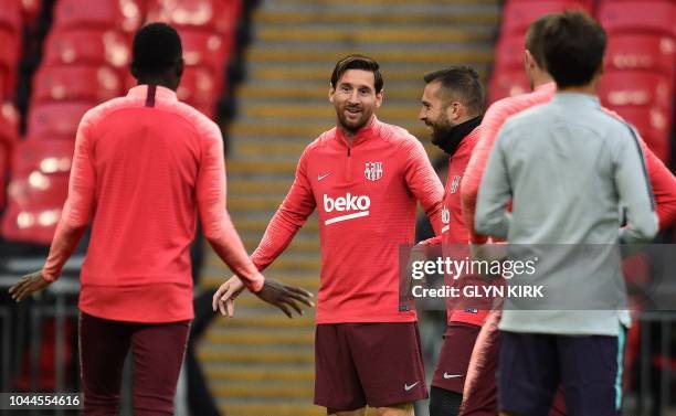 Barcelona's Argentine forward Lionel Messi and Barcelona's Spanish defender Jordi Alba attends a team training session at Wembley Stadium in north...