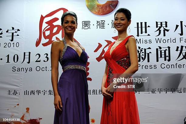 Miss World 2009 Kaiane Aldorino of Gibraltar poses with Miss China 2010 Tang Xiao during a press conference in Beijing on September 25 to announce...