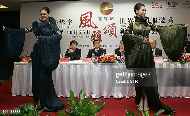 Miss World 2009 Kaiane Aldorino of Gibraltar and Miss China 2010 Tang Xiao dress in costumes as they pose during a press conference in Beijing on...