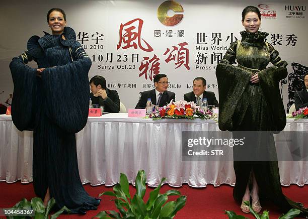 Miss World 2009 Kaiane Aldorino of Gibraltar and Miss China 2010 Tang Xiao dress in costumes as they pose during a press conference in Beijing on...