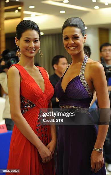 Miss World 2009 Kaiane Aldorino of Gibraltar poses with Miss China 2010 Tang Xiao during a press conference in Beijing on September 25 to announce...