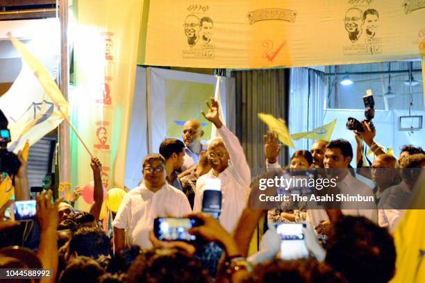 Opposition Maldivian Democratic Party presidential candidate Ibrahim Mohamed Solih waves to his supporters as he declares the victory on September...