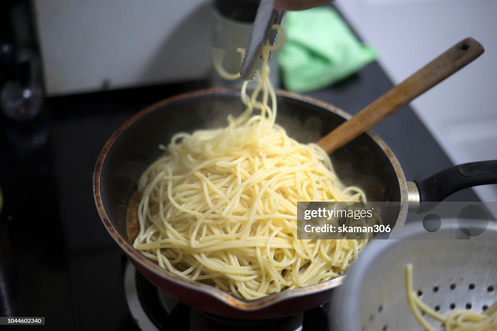 Boiled water and spaghetti noodle for cooking italian pasta