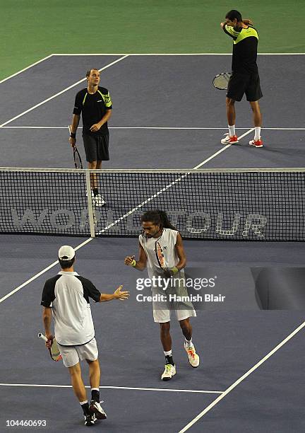 Rogier Wassen of Netherlands celebrates a break of serve with team mate Dustin Brown of Jamaica looking on during the doubles final against Marcelo...