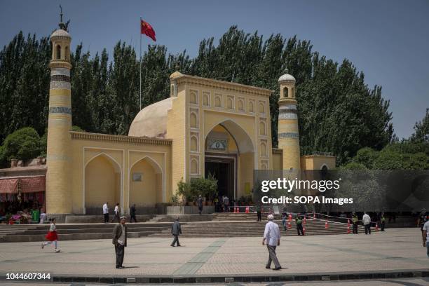 Uighur Chinese local Muslims making their way to the Id Kah Mosque for Friday afternoon prayers under police surveillance in the Kashgar old Town,...