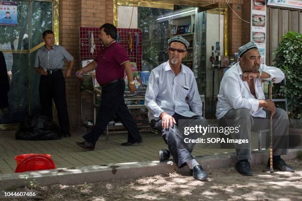 Uighur Chinese local Muslims attends Friday afternoon prayers near the Id Kah Mosque under police surveillance in the Kashgar old Town, northwestern...