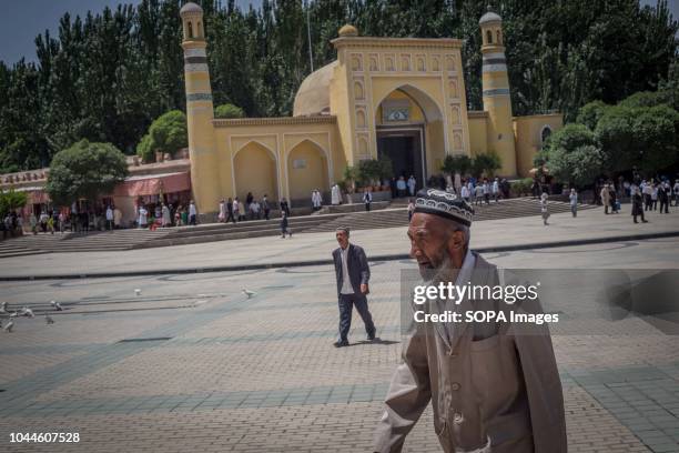 Uighur Chinese local Muslims leave Id Kah Mosque after Friday afternoon prayers in the Kashgar old Town, northwestern Xinjiang Uyghur Autonomous...