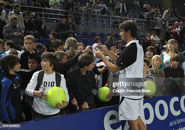 Rogier Wassen of Netherlands signs autogrpahs after his victory with team mate Dustin Brown of Jamaica in the doubles final against Marcelo Melo and...