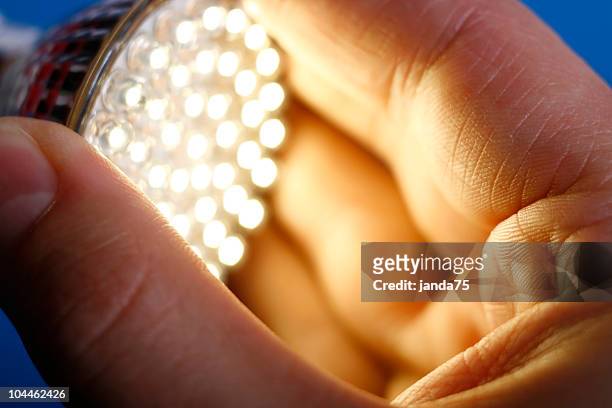 led light in hand - leds stock pictures, royalty-free photos & images