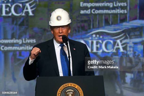 President Donald Trump wears a hard hat as he addresses the National Electrical Contractors Convention on October 2, 2018 in Philadelphia,...