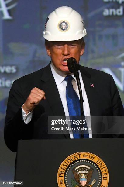 President Donald Trump wears a hard hat as he addresses the National Electrical Contractors Convention on October 2, 2018 in Philadelphia,...