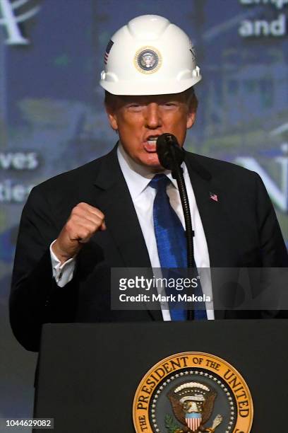 President Donald Trump wears a hard hat as he addresses the National Electrical Contractors Convention on October 2, 2018 in Philadelphia,...