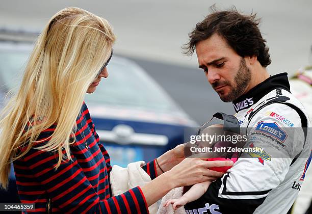 Jimmie Johnson , driver of the Lowe's Chevrolet, and his wife Chandra play with their daughter Genevieve Marie on the grid prior to the NASCAR Sprint...