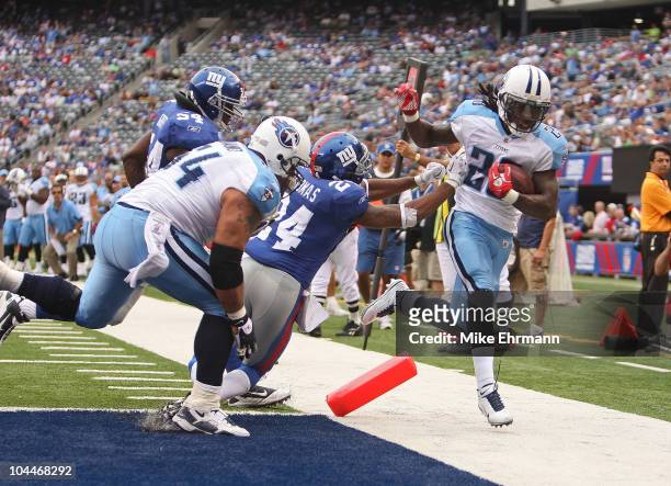 Chris Johnson of the Tennessee Titans is pushed out of bounds at the endzone by Terrell Thomas of the New York Giants at New Meadowlands Stadium on...