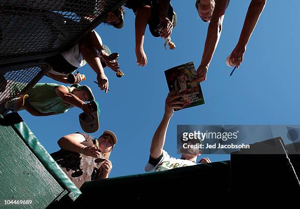 Dallas Braden of the Oakland Athletics signs autographs before his game against the Texas Rangers during a Major League Baseball game at the...